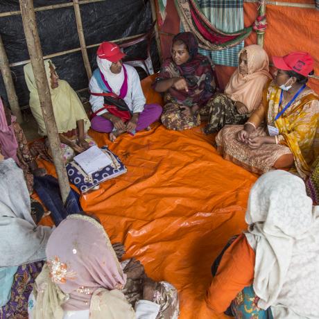 A women's commitee meeting discusses health issues at a Rohingya refugee camp